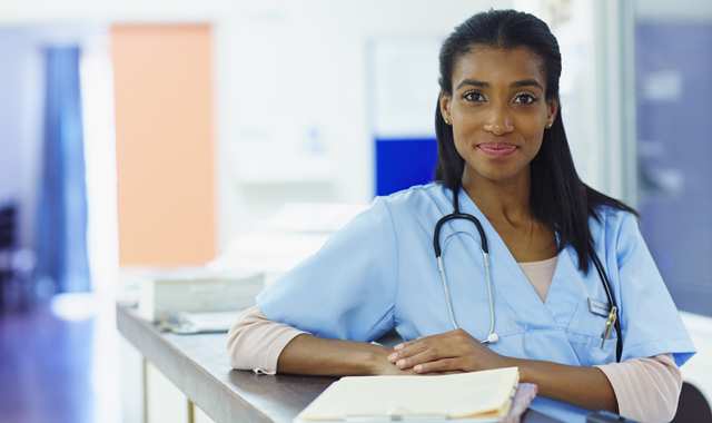 nurse standing at a desk