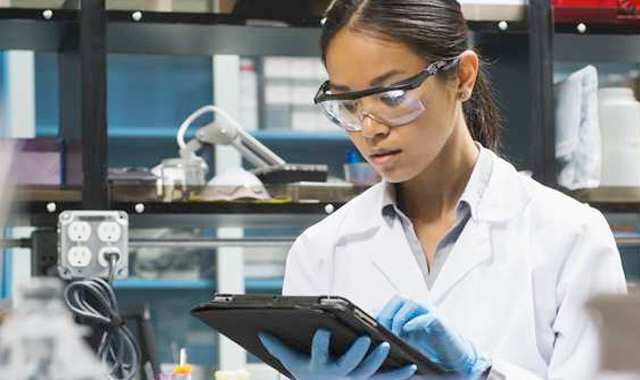 researcher in a lab working on a tablet