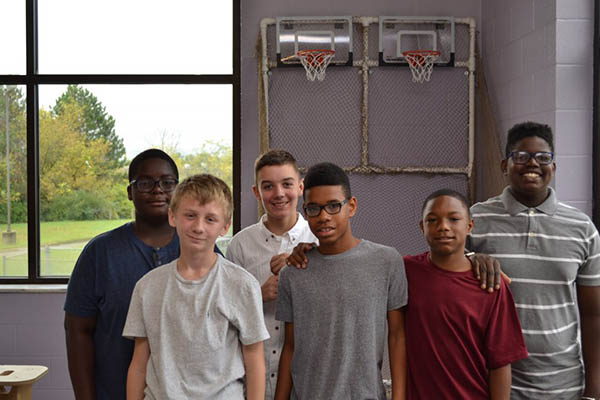 Students posing with their basketball game creation