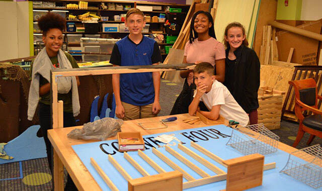 STEM-arcade-header1 Students showing off their hand-built arcade game