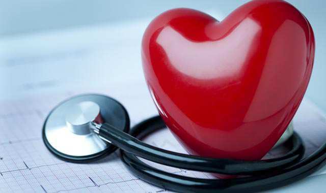 Red rubber heart with stethoscope around it.