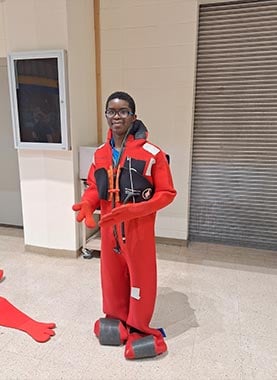 alt=a stem student from the Kenai Peninsula Borough School Districts wearing a power plant suit