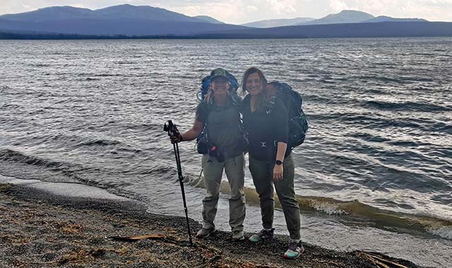 Photo: Dana Skorupa of Montana State University and Fadime Murdoch of Battelle stop for a short rest along the shore of Heart Lake in Yellowstone National Park. 