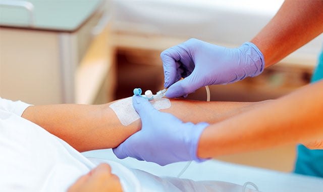 Image: Caregiver inserting an IV device