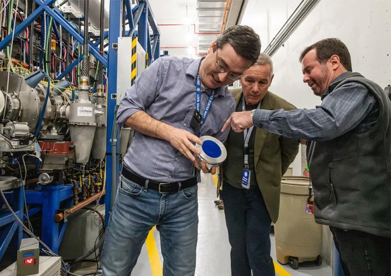 Ed Anderson, right, discusses a machine component with George Laity, left, and Mark Davis during a tour of Dual-Axis Radiographic Hydrodynamic Test Facility