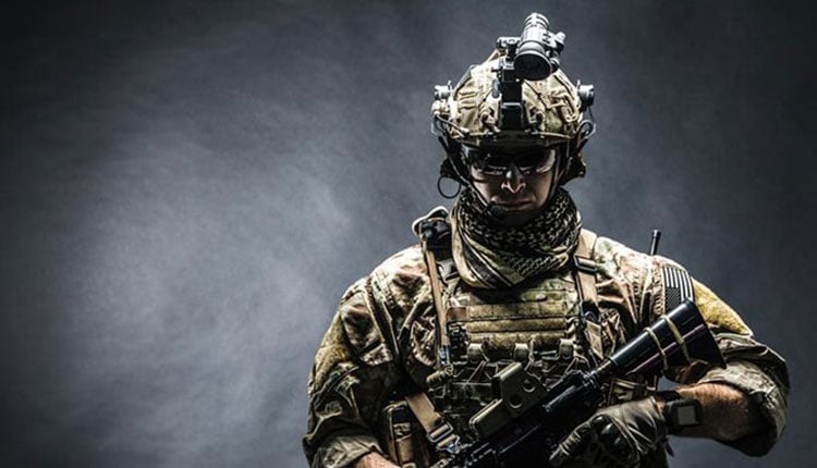 Image: Human operator in tactical gear against a gray background