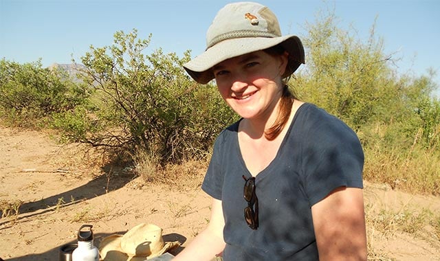 alt=Kate Thibault in the field in 2011, using a wildlife PIT tag reader.