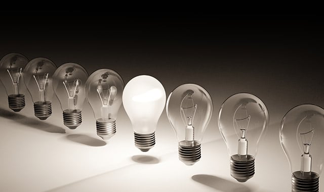 alt=a lit lightbulb in a line of dim lightbulbs