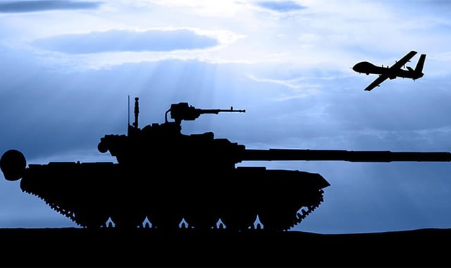 alt= black silhouette of a tank and a plane flying above it