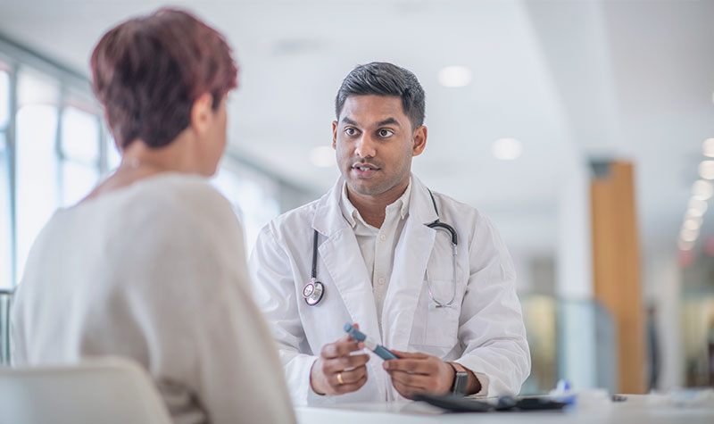 Image: Healthcare professional training a patient on usage of a medical device